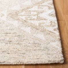 a white rug on top of a wooden floor