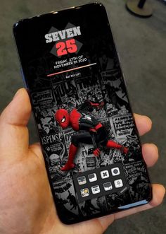 someone is holding up their phone with the spiderman theme on it, and there is also an advertisement for the phone