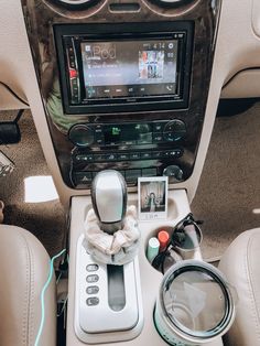 the interior of a car with an entertainment system and steering wheel controls on it's center console