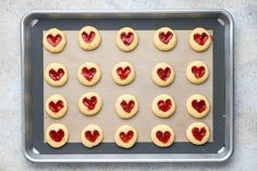 heart shaped cookies on a cookie sheet ready to go into the oven for valentine's day