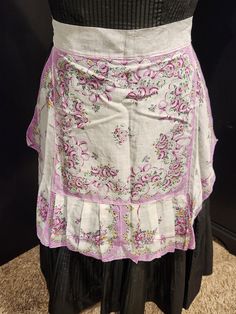 a woman's skirt with pink and white flowers on it