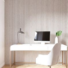 a white desk with a computer on it in front of a striped wallpapered wall