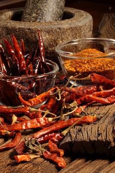 some chilis and spices on a wooden table