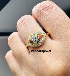 a woman's hand with a diamond ring on top of her finger and the words panorajewe above it