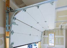 the interior of a house being remodeled with white paint and roller shades on the windows