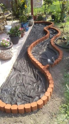 an outdoor garden area is being constructed with bricks and tarp to protect it from the sun