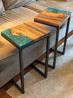 two wooden tables sitting on top of a couch