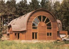 a large wooden building sitting in the middle of a forest