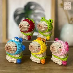 small crocheted toy animals sitting on top of a wooden table