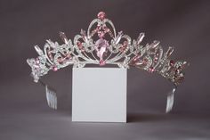 A small pink crown. The crown is perfect for both children and adults due to its small size and weight. Beautiful sparkling tiara with pink crystals in gold or silver plated. Incredible tiara that will look great on the bride. I'm sure you will get a lot of compliments. Height of the tiara - 2"( 5 см) Features: Tiara made with pink crystals and rhinestones Sturdy metal frame Delicate crystal pattern Care instructions: Avoid contact with water Clean with a soft cloth Store in a cool, dry place Pa Cute Pink Hair Accessories, Pink Crowns, Pink Princess Crown, Pink Tiara, Tiara Silver, Pink Quince, Princess Charm School, Headband Crystal, Crown Pink