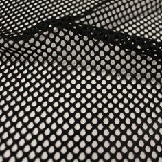 black and white polka dot mesh fabric with small dots on the top, close up