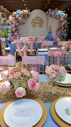 a table set up with pink and gold plates, napkins and flowers on it