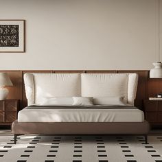 a large bed sitting on top of a white and black floor next to two lamps