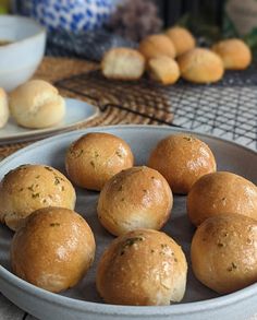 some rolls are in a bowl on a table