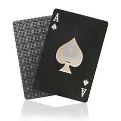 two black and gold playing cards with ace symbols on each card, one in the shape of a spade