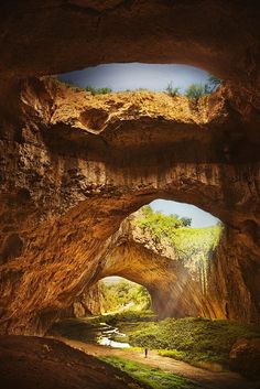 an image of the inside of a cave with sunlight coming in from the entrance to it