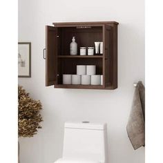 a wooden cabinet above a toilet in a bathroom