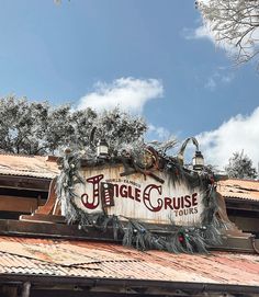 a sign on top of a building that says jungle cruise tours in front of it