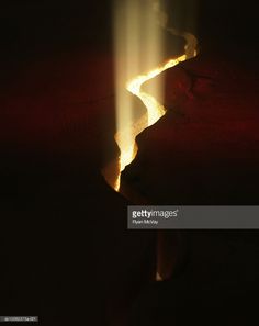 the light shines brightly on a narrow stream of water in the dark stock photo