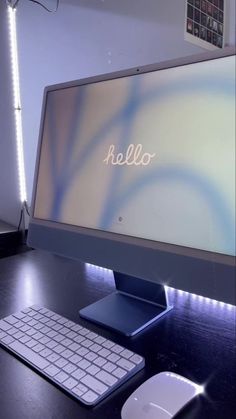 a desktop computer monitor sitting on top of a desk next to a keyboard and mouse