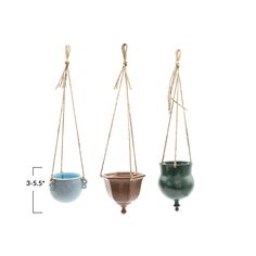 three hanging planters with ropes attached to them, one blue and the other green