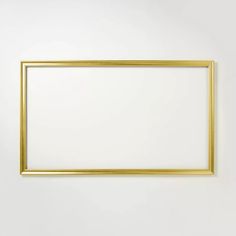 an empty gold frame hanging on the wall