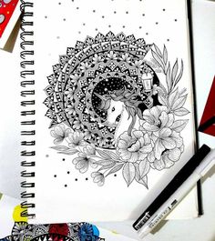 a drawing of a woman's head surrounded by flowers and leaves on a spiral notebook