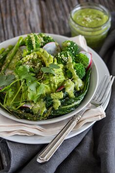 a white plate topped with broccoli and radishes on top of a table