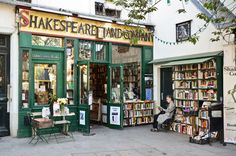 people are sitting outside in front of shakespeare's fairy land bookshops with tables and chairs