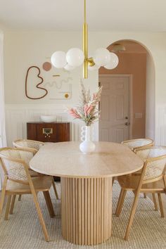 a dining room table with four chairs around it