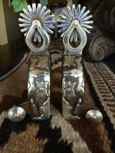 pair of silver metal door handles with flowers on each side and two bells at the top