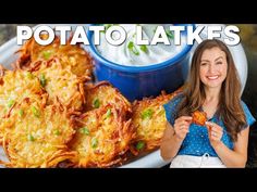 a woman is holding up some potato cakes