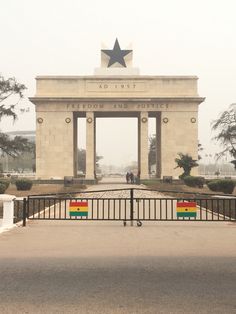 a gate with two benches in front of it that has a star on the top