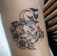 a black and white photo of a pumpkin tattoo