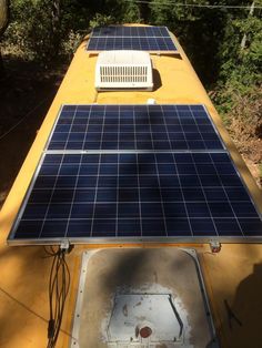 a solar panel mounted on top of a yellow roof