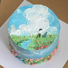 there is a cake decorated with flowers and clouds