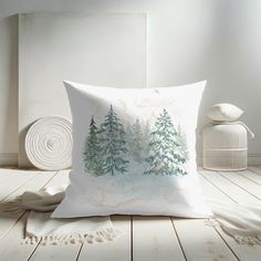 a white pillow sitting on top of a wooden floor