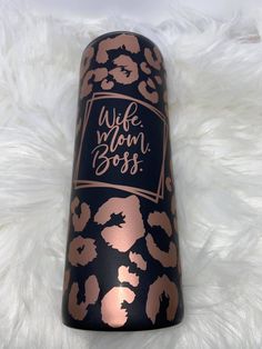 a wine bottle with the words wife boss on it sitting on a white fur rug