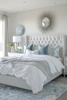 a white bed sitting in a bedroom next to a window