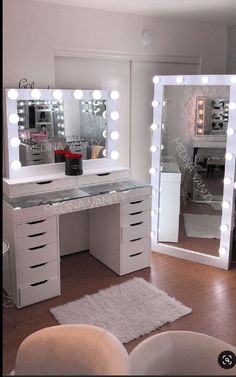 a white vanity with lighted mirror and stool