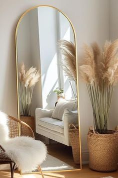 a mirror sitting on top of a wooden floor next to a chair and potted plants