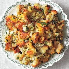 a white plate topped with stuffing on top of a table