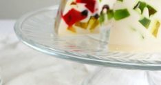 two pieces of cake sitting on top of a glass platter with white frosting