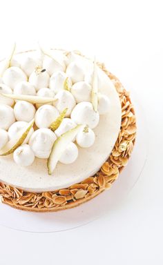 a white cake topped with marshmallows on top of a wicker basket