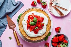 there is a pie with strawberries on the table