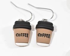 two coffee cup earrings with the word coffee printed on them