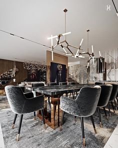 an elegant dining room with black chairs and a marble table surrounded by art deco artwork