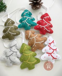 felt christmas tree ornaments on a white table