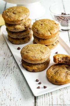 chocolate chip cookies are stacked on a white plate