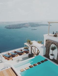 an outdoor swimming pool next to the ocean